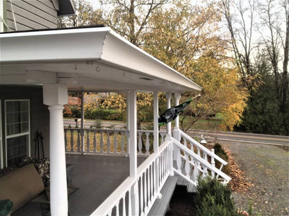 GutterAll.com Spanish Curved Style Gutter installed on white home - showcasing elegant curved profile and professional finish